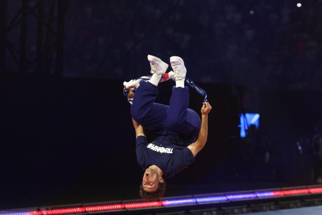 Paris Saint-Germain's Portuguese midfielder #87 Joao Neves does a backflip as he arrives onto the pitch during a ceremony to present the trophy a day after Paris Saint-Germain (PSG) football club won the UEFA Champions League, at the Parc des Princes Stadium in Paris on June 1, 2025. (Photo by FRANCK FIFE / AFP)
