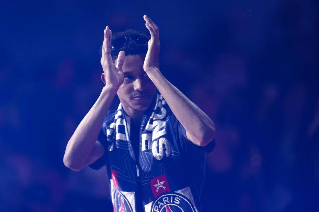 Paris Saint-Germain's French midfielder #24 Senny Mayulu celebrates on the stage during a ceremony to present the trophy a day after Paris Saint-Germain (PSG) football club won the UEFA Champions League, at the Parc des Princes Stadium in Paris on June 1, 2025. (Photo by Thibaud MORITZ / AFP)
