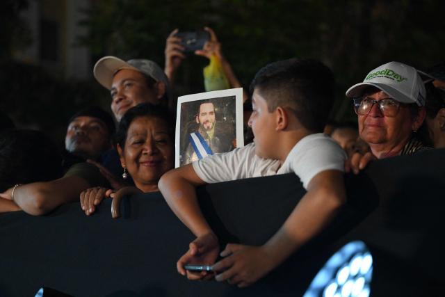 Supporters of El Salvador's President Nayib Bukele listen his first-year speech outside the National Theatre in San Salvador on June 1, 2025. (Photo by Marvin RECINOS / AFP)