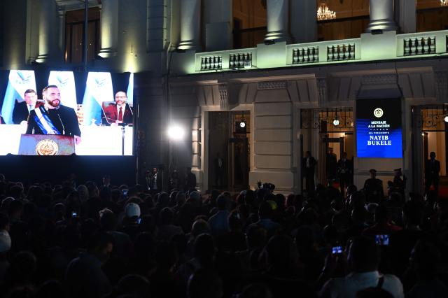 Supporters of El Salvador's President Nayib Bukele listen his first-year speech outside the National Theatre in San Salvador on June 1, 2025. (Photo by Marvin RECINOS / AFP)