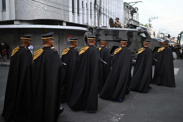 Members of the Presidential Guard secure the area before El Salvador's President Nayib Bukele delivers his first-year speech outside the National Theatre in San Salvador on June 1, 2025. (Photo by Marvin RECINOS / AFP)