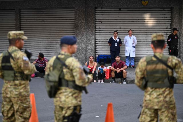 Army soldiers secure the area before El Salvador's President Nayib Bukele delivers his first-year speech outside the National Theatre in San Salvador on June 1, 2025. (Photo by Marvin RECINOS / AFP)
