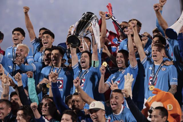Cruz Azul's Uruguayan midfielder #15 Ignacio Rivero lifts the trophy next to teammates after winning the CONCACAF Champions Cup final football match between Mexico's Cruz Azul and Canada's Vancouver Whitecaps at the Olimpico Universitario Stadium in Mexico City on June 1, 2025. (Photo by DANIEL GAMEZ GUTIERREZ / AFP)