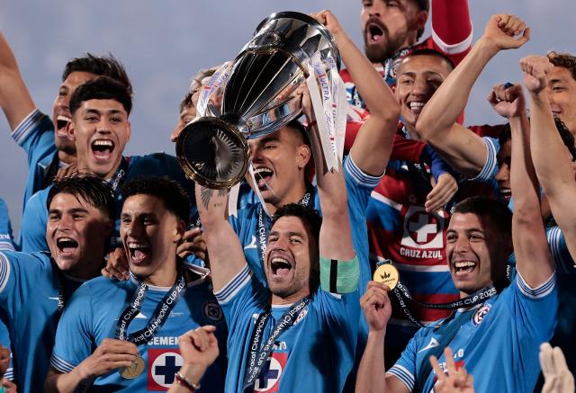 Cruz Azul's Uruguayan midfielder #15 Ignacio Rivero lifts the trophy next to teammates after winning the CONCACAF Champions Cup final football match between Mexico's Cruz Azul and Canada's Vancouver Whitecaps at the Olimpico Universitario Stadium in Mexico City on June 1, 2025. (Photo by DANIEL GAMEZ GUTIERREZ / AFP)