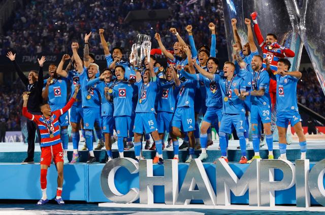 Cruz Azul's Uruguayan midfielder #15 Ignacio Rivero lifts the trophy next to teammates after winning the CONCACAF Champions Cup final football match between Mexico's Cruz Azul and Canada's Vancouver Whitecaps at the Olimpico Universitario Stadium in Mexico City on June 1, 2025. (Photo by DANIEL GAMEZ GUTIERREZ / AFP)