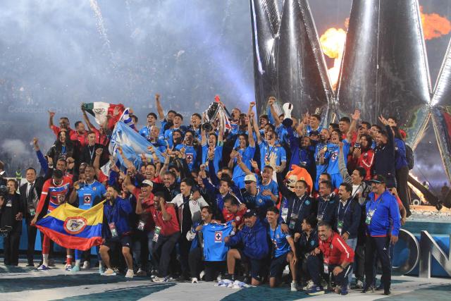 Cruz Azul's Uruguayan midfielder #15 Ignacio Rivero lifts the trophy next to teammates after winning the CONCACAF Champions Cup final football match between Mexico's Cruz Azul and Canada's Vancouver Whitecaps at the Olimpico Universitario Stadium in Mexico City on June 1, 2025. (Photo by Victor Cruz / AFP)