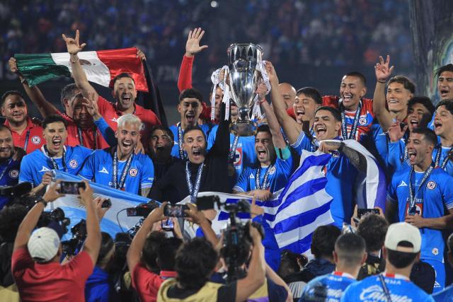 Cruz Azul's Uruguayan interim coach Vicente Sanchez and Uruguayan midfielder #15 Ignacio Rivero lift the trophy after winning the CONCACAF Champions Cup final football match between Mexico's Cruz Azul and Canada's Vancouver Whitecaps at the Olimpico Universitario Stadium in Mexico City on June 1, 2025. (Photo by Victor Cruz / AFP)