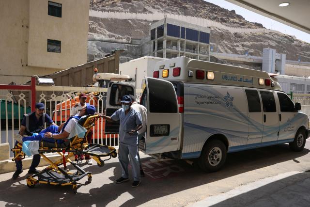 Saudi medics transport a man to  the Mina Emergency Hospital in the holy city of Mecca on June 1, 2025, where a heat stroke treatment unit was set up as Muslim pilgrims arrive for the annual Hajj pilgrimage. More than a million Muslim pilgrims poured into the holy city of Mecca ahead of the annual hajj, with authorities vowing to hold a safer pilgrimage amid searing desert heat and a massive crackdown on illegal visitors. (Photo by HAZEM BADER / AFP)