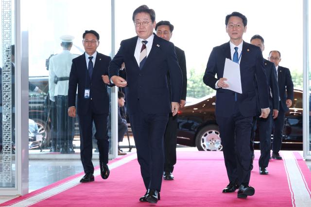 South Korea's President Lee Jae-myung (C) arrives at the presidential office following his inauguration ceremony in Seoul on June 4, 2025. (Photo by Chung Sung-Jun / POOL / AFP)