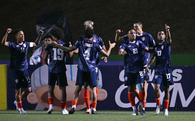 Dominican forward #17 Dorny Romero celebrates with his teammates after scoring an equalizing goal during the 2026 FIFA World Cup Concacaf qualifier football match between Guatemala and Dominican Republic at the Cementos Progreso stadium in Guatemala city on June 6, 2025. (Photo by JOHAN ORDONEZ / AFP)