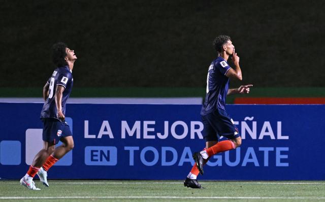 Dominican midfielder #08 Heinz Morschel (R) celebrates after scoring during the 2026 FIFA World Cup Concacaf qualifier football match between Guatemala and Dominican Republic at the Cementos Progreso stadium in Guatemala city on June 6, 2025. (Photo by JOHAN ORDONEZ / AFP)