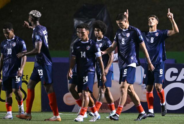 Dominican midfielder #08 Heinz Morschel celebrates with teammates| after scoring during the 2026 FIFA World Cup Concacaf qualifier football match between Guatemala and Dominican Republic at the Cementos Progreso stadium in Guatemala city on June 6, 2025. (Photo by JOHAN ORDONEZ / AFP)