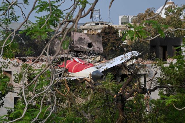 Wreckage showing the tail section of the Air India Boeing 787-8 is pictured in a residential area near the airport in Ahmedabad on June 14, 2025, after the aircraft operating as flight 171 crashed shortly after taking off on June 12. Investigators recovered a black box recorder on June 13 from the crash site of a London-bound passenger jet that ploughed into a residential area of India's Ahmedabad city, killing at least 265 people on board and on the ground. (Photo by Punit PARANJPE / AFP)