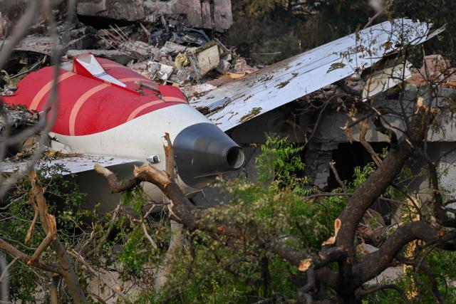 Wreckage showing the tail section of the Air India Boeing 787-8 is pictured in a residential area near the airport in Ahmedabad on June 14, 2025, after the aircraft operating as flight 171 crashed shortly after taking off on June 12. Investigators recovered a black box recorder on June 13 from the crash site of a London-bound passenger jet that ploughed into a residential area of India's Ahmedabad city, killing at least 265 people on board and on the ground. (Photo by Punit PARANJPE / AFP)