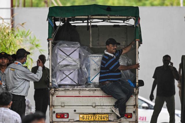 A truck loaded with victims' coffins arrives at a mortuary inside the hospital complex in Ahmedabad on June 14, 2025, after Air India flight 171 crashed in a residential area near the airport on June 12. The death toll from the fiery crash of a London-bound passenger jet in an Indian city climbed to 279 on June 14 as officials sought to match the DNA of victims with their grieving relatives. (Photo by Punit PARANJPE / AFP)