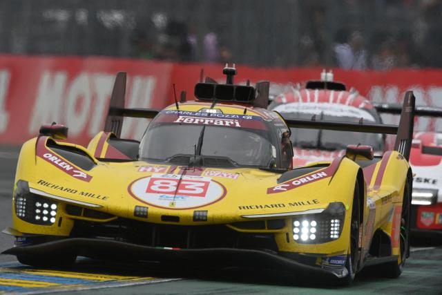 AF Corse's British driver #83 Philip Hanson (L) steers his hypercar in front of Porsche Penske Motorsport's French driver #6 Kevin Estre (R) during the 2025 Le Mans 24 hour endurance race, at the Le Mans circuit, in north-western France on June 14, 2025. (Photo by JEAN-FRANCOIS MONIER / AFP)
