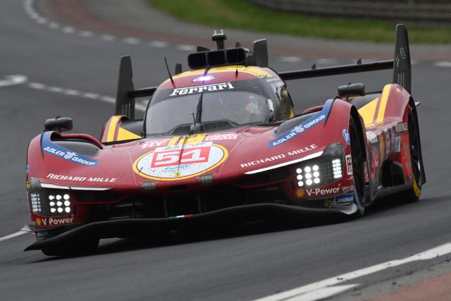 Ferrari AF Corse's Italian driver #51 Antonio Giovinazzi steers his hypercar during the 2025 Le Mans 24 hour endurance race, at the Le Mans circuit, in north-western France on June 14, 2025. (Photo by JEAN-FRANCOIS MONIER / AFP)