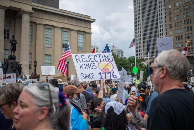 A protester holds a placard during a nationwide "No Kings" rally in downtown Louisville, Kentucky, on June 14, 2025, on the same day as President Donald Trump's military parade in Washington, DC. Thousands of people rallied across the United States on June 14 as a so-called "No Kings" has sprung up against the policies of US President Donald Trump, ahead of a rare military parade on his 79th birthday. (Photo by LEANDRO LOZADA / AFP)