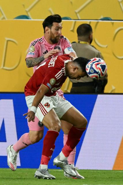 Inter Miami's Argentine forward #10 Lionel Messi and Al Ahly's Egyptian midfielder #07 Trezeguet fight for the ball during the Club World Cup 2025 Group A football match between Egypt's Al-Ahly and US Inter Miami at the Hard Rock stadium in Miami on June 14, 2025. (Photo by CHANDAN KHANNA / AFP)