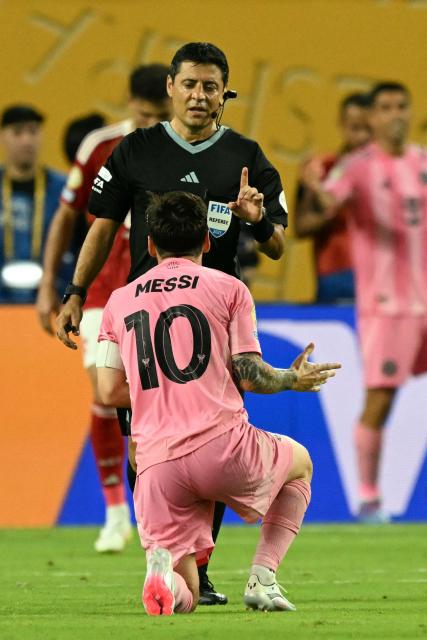 Iranian-Australian referee Alireza Faghani gestures to Inter Miami's Argentine forward #10 Lionel Messi during the Club World Cup 2025 Group A football match between Egypt's Al-Ahly and US Inter Miami at the Hard Rock stadium in Miami on June 14, 2025. (Photo by CHANDAN KHANNA / AFP)