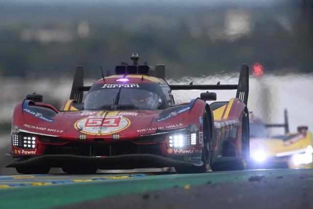 Ferrari AF Corse Thor Team's hypercar #51 British driver James Calado competes in front of Ferrari AF Corse Thor Team's hypercar #83 British driver Philip Hanson during the 2025 Le Mans 24 hour endurance race, at the Le Mans circuit, in northwestern France, on June 15, 2025. (Photo by JEAN-FRANCOIS MONIER / AFP)