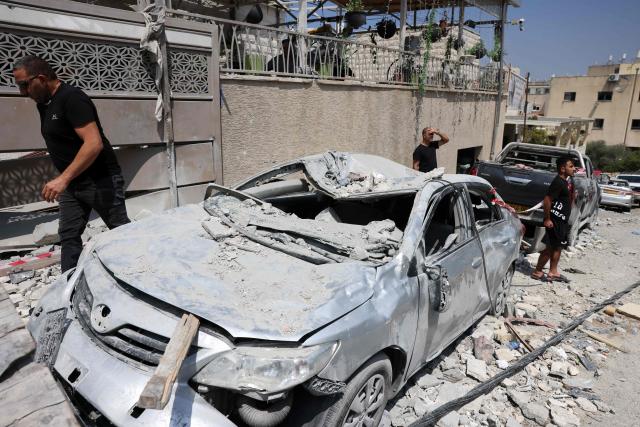 Residents check the damage in the northern Israeli village of Tamra, following an overnigh missile attack from Iran on June 15, 2025, where four people, including a child, were reported killed. Iranian missile fire on Israel killed at least 10 people overnight, authorities said on June 15, as the foes exchanged new waves of attacks in their most intense confrontation in history. (Photo by AHMAD GHARABLI / AFP)