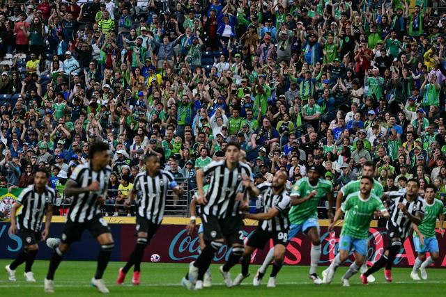 Fans of Seattle Sounders cheer for their team during the Club World Cup 2025 Group B football match between Brazil's Botafogo and US Seattle Sounders at the Lumen Field stadium in Seattle on June 15, 2025. (Photo by Pablo PORCIUNCULA / AFP)