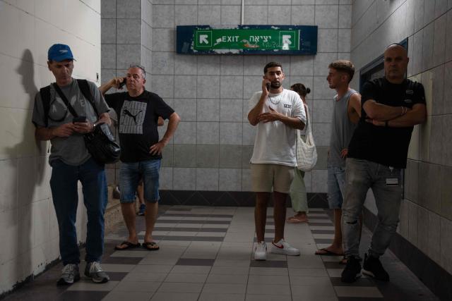 Israelis take shelter during a missile siren alert in Haifa, on June 16, 2025. Israel and Iran traded deadly fire for a fourth day on June 16 in their most intense confrontation in history, fuelling fears of a drawn-out conflict that could engulf the Middle East. (Photo by Maya Levin / AFP)