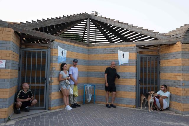 Israelis take shelter during a missile siren alert in Haifa, on June 16, 2025. Israel and Iran traded deadly fire for a fourth day on June 16 in their most intense confrontation in history, fuelling fears of a drawn-out conflict that could engulf the Middle East. (Photo by Maya Levin / AFP)