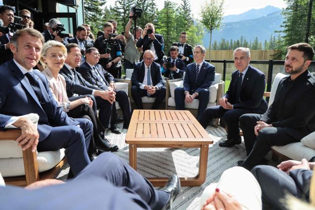 (L/R) French President Emmanuel Macron, European Commission President Ursula Von der Leyen, NATO Secretary General Mark Rutte, Japanese Prime Minister Shigeru Ishiba, German Chancellor Friedrich Merz, US Secretary of Treasury Scott Bessent, Canadian Prime Minister Mark Carney, and Ukrainian President Volodymyr Zelenskyy during the Group of Seven (G7) Summit at the Pomeroy Kananaskis Mountain Lodge in Kananaskis, Alberta, Canada on June 17, 2025. Canadian Prime Minister Mark Carney on Tuesday announced Can$2 billion ($1.47bn) of military support including drones and helicopters for Ukraine as he hosted President Volodymyr Zelensky at a G7 summit. Carney vowed "total solidarity with Ukraine" as he also unveiled further sanctions on Russia in an effort to impose "maximum pressure" on President Vladimir Putin over the war. (Photo by Ludovic MARIN / AFP)