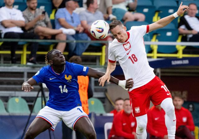 France's defender #14 Christian Mawissa and Poland's midfielder #18 Dominik Marczuk  (R) vie for the ball during the UEFA U21 European Championship Group C football match between France and Poland in Zilina, Slovakia on June 17, 2025. (Photo by Joe Klamar / AFP)