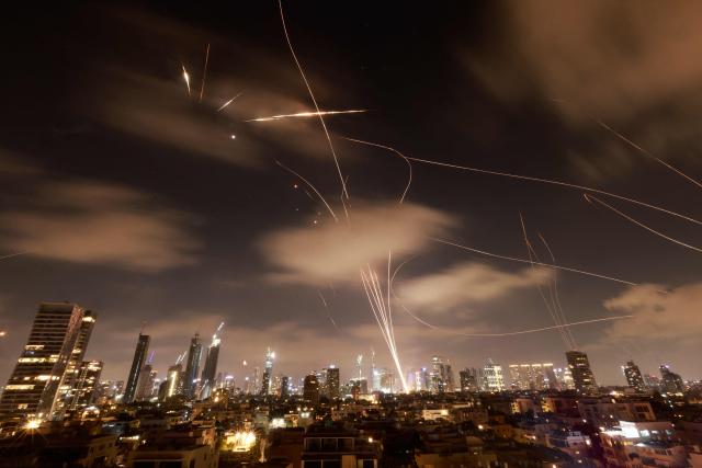 Israeli air defence systems are activated to intercept Iranian missiles over the Israeli city of Tel Aviv early on June 18, 2025. Israel and Iran exchanged fire again on June 17, the fifth day of strikes in their most intense confrontation in history, fuelling fears of a drawn-out conflict that could engulf the Middle East. (Photo by Menahem Kahana / AFP)