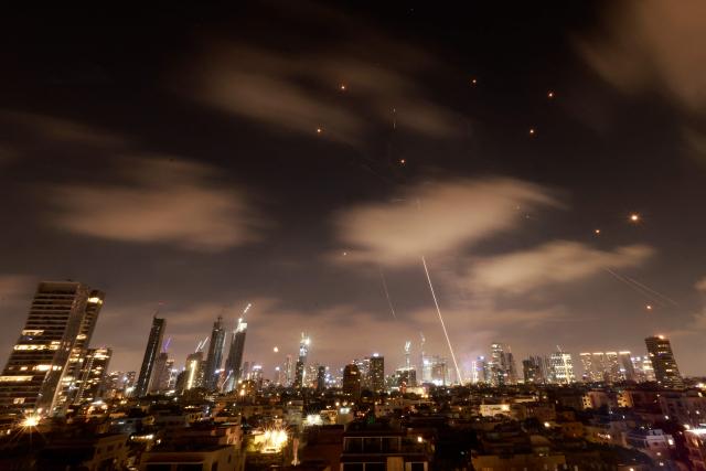 Israeli air defence systems are activated to intercept Iranian missiles over the Israeli city of Tel Aviv early on June 18, 2025. Israel and Iran exchanged fire again on June 17, the fifth day of strikes in their most intense confrontation in history, fuelling fears of a drawn-out conflict that could engulf the Middle East. (Photo by Menahem Kahana / AFP)