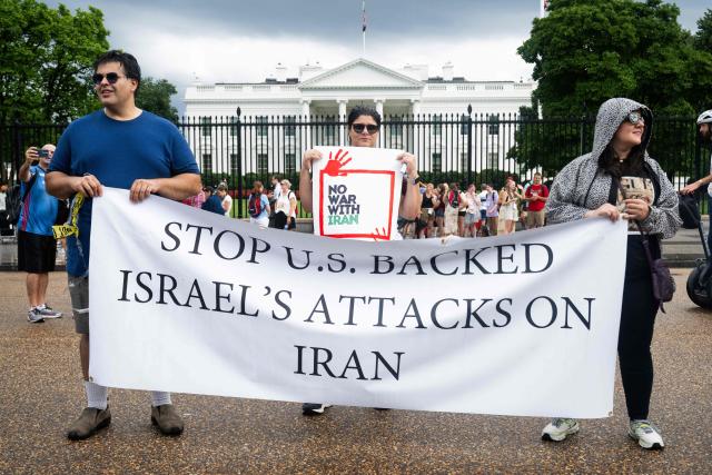 People protest the Israeli strikes on Iran and any potential US involvement in the conflict during a "No War on Iran" demonstration outside the White House in Washington, DC, on June 18, 2025. US President Donald Trump said on June 18 that he was still deciding whether to join Israel's strikes on Iran, claiming Tehran now wants talks at the White House but may have waited too long. (Photo by SAUL LOEB / AFP)
