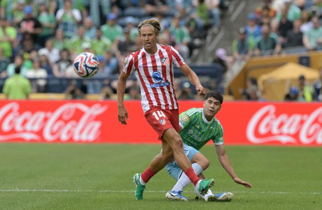 Atletico Madrid's Spanish midfielder #14 Marcos Llorente and Seattle Sounders' Mexican midfielder #18 Obed Vargasfight for the ball during the FIFA Club World Cup 2025 Group B football match between US Seattle Sounders and Spain's Atletico de Madrid at the Lumen Field stadium in Seattle on June 19, 2025. (Photo by JUAN MABROMATA / AFP)