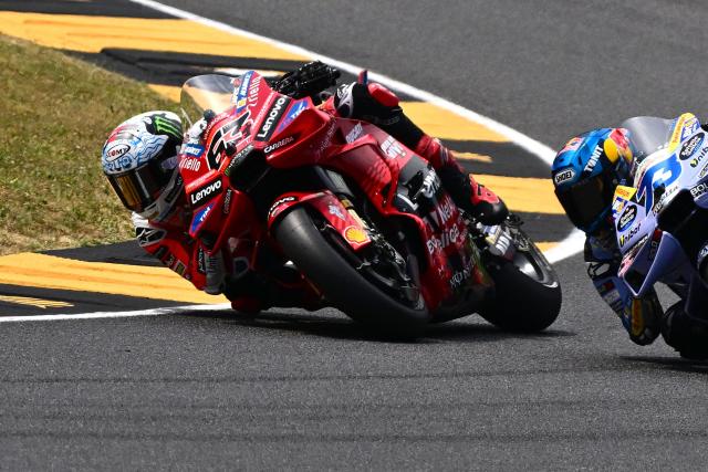Ducati Lenovo Team's Italian MotoGP rider Francesco Bagnaia (#63) steers his motorbike ahead of BK8 Gresini Racing MotoGP team's Spanish MotoGP rider Alex Marquez during the sprint on the eve of the Italian Moto GP Grand Prix at Mugello circuit, in Mugello, near Florence, on June 21, 2025. (Photo by Tiziana FABI / AFP)