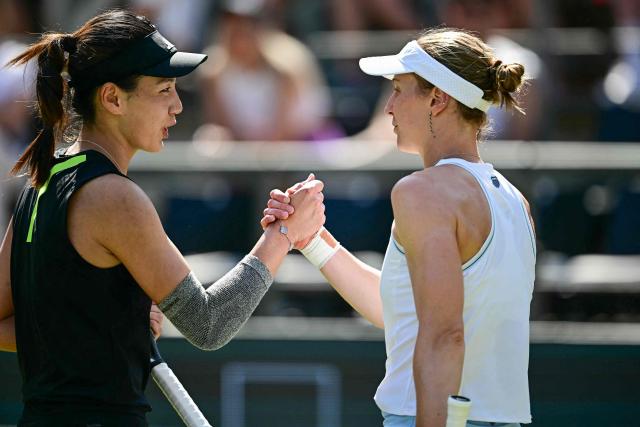China's Wang Xinyu (L) is congratulted by Russia's Liudmila Samsonova after their semi-final match at the WTA tennis tournament in Berlin on June 21, 2025. (Photo by Tobias SCHWARZ / AFP)
