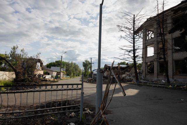 This photograph shows a destroyed school (L) in the city of Svyatohirs'k, Donetsk region on June 26, 2025, amid the Russian invasion of Ukraine. (Photo by Tetiana DZHAFAROVA / AFP)