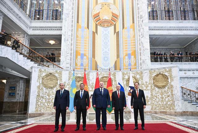 In this pool photograph distributed by the Russian state agency Sputnik, Kazakhstan’s President Kassym-Jomart Tokayev, Kyrgyzstan's President Sadyr Japarov, Belarusian President Alexander Lukashenko, Russia's President Vladimir Putin and Chairman of the Board of the Eurasian Economic Commission (EEC) Bakytzhan Sagintayev pose for a family photo prior to a meeting of the Supreme Eurasian Economic Council at the Independence Palace in Minsk on June 27, 2025. (Photo by Sergei BOBYLYOV / POOL / AFP)