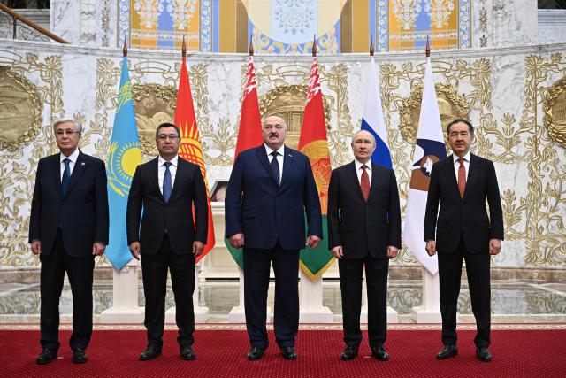 In this pool photograph distributed by the Russian state agency Sputnik, Kazakhstan’s President Kassym-Jomart Tokayev, Kyrgyzstan's President Sadyr Japarov, Belarusian President Alexander Lukashenko, Russia's President Vladimir Putin and Chairman of the Board of the Eurasian Economic Commission (EEC) Bakytzhan Sagintayev pose for a family photo prior to a meeting of the Supreme Eurasian Economic Council at the Independence Palace in Minsk on June 27, 2025. (Photo by Sergei BOBYLYOV / POOL / AFP)