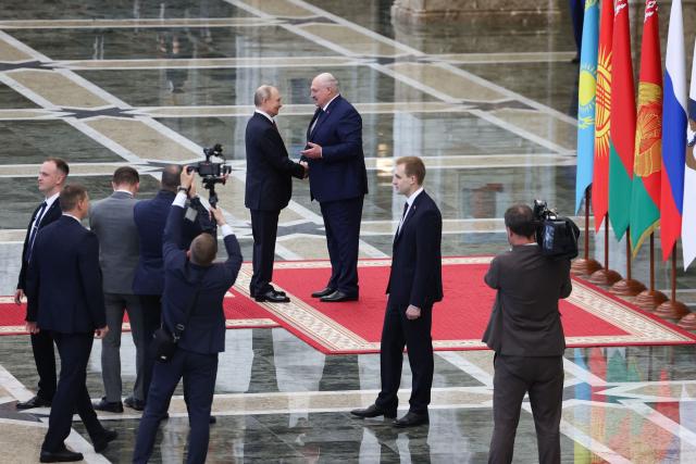 In this pool photograph distributed by the Russian state agency Sputnik, Belarusian President Alexander Lukashenko greets Russia's President Vladimir Putin prior to a meeting of the Supreme Eurasian Economic Council at the Independence Palace in Minsk on June 27, 2025. (Photo by Alexander KAZAKOV / POOL / AFP)