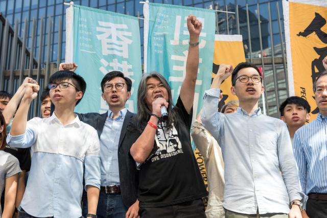 (FILES) (From L to R) Student protest leader Joshua Wong, Hong Kong pro-democracy party League of Social Democrats (LSD) chairman Avery Ng, pro-democracy lawmaker Leung Kwok-hung, also known as "Long Hair", and pro-democracy lawmaker Nathan Law hold a protest against their recent arrests and detention ahead of the visit by China's President Xi Jinping, outside Civic Square at the Central Government Offices in Hong Kong on June 30, 2017. Hong Kong's League of Social Democrats, one of the city's last remaining opposition parties after a five-year political crackdown by Beijing, said on June 27, 2025, that it will disband. (Photo by Jayne Russell / AFP)