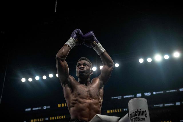 France's Christian Mbilli celebrates his victory over unseen Poland's Maciej Sulecki during their WBC Interim Super Middleweight title bout at the Videotron Centre in Quebec City, Quebec, Canada, on June 27, 2025. (Photo by ANDREJ IVANOV / AFP)