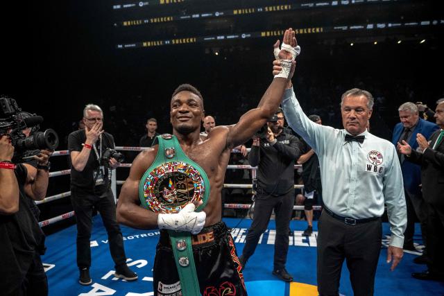 France's Christian Mbilli (L) celebrates his victory over unseen Poland's Maciej Sulecki during their WBC Interim Super Middleweight title bout at the Videotron Centre in Quebec City, Quebec, Canada, on June 27, 2025. (Photo by ANDREJ IVANOV / AFP)