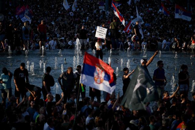 People wave Serbian national flags as tens of thousands of protesters gather in central Belgrade as they issue an "ultimatum" to the populist government to call early elections after months of student-led strikes across the country, in Belgrade, on June 28, 2025. Anti-graft protests have rocked the Balkan nation since November when 16 people were killed in the northern city of Novi Sad by a train station roof collapse, a tragedy widely blamed on entrenched corruption. For over half a year, students have blockaded universities and organised large demonstrations around the country, demanding a transparent investigation into the tragedy with their focus shifting after little action from authorities to call for early parliamentary elections. (Photo by OLIVER BUNIC / AFP)