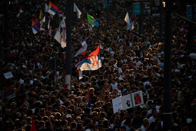 People wave Serbian national flags as tens of thousands of protesters gather in central Belgrade as they issue an "ultimatum" to the populist government to call early elections after months of student-led strikes across the country, in Belgrade, on June 28, 2025. Anti-graft protests have rocked the Balkan nation since November when 16 people were killed in the northern city of Novi Sad by a train station roof collapse, a tragedy widely blamed on entrenched corruption. For over half a year, students have blockaded universities and organised large demonstrations around the country, demanding a transparent investigation into the tragedy with their focus shifting after little action from authorities to call for early parliamentary elections. (Photo by OLIVER BUNIC / AFP)