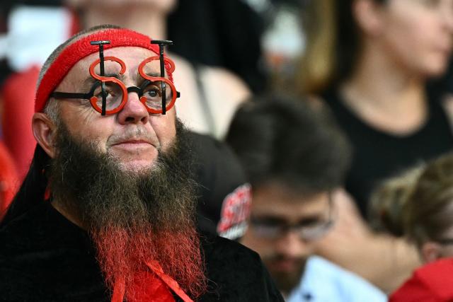 A Stade Toulousain supporter wearing glasses in the shape of the team's initials looks on  in the stands prior to the French Top 14 rugby union final match between the Stade Toulousain (Toulouse) and Union Bordeaux-Begles (UBB) at the Stade de France stadium in Saint-Denis, north of Paris, on June 28, 2025. (Photo by MARTIN BUREAU / AFP)