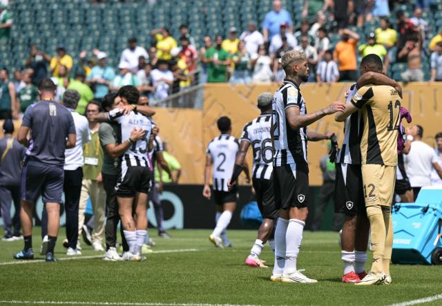 Botafogo's Brazilian goalkeeper #12 John (R) is comforted by teammates after the FIFA Club World Cup 2025 round of 16 all-Brazilian football match between Palmeiras and Botafogo at Lincoln Financial Field Stadium in Philadelphia on June 28, 2025. (Photo by JUAN MABROMATA / AFP)