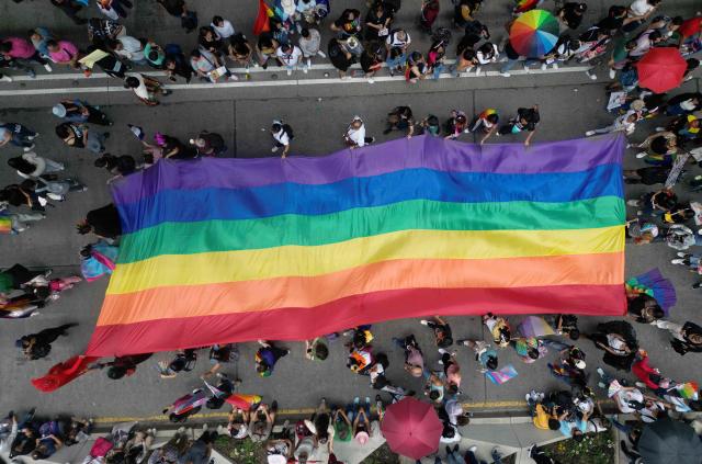 In this aerial view revelers hold a large rainbow flag during the Pride Parade in Mexico City on June 28, 2025. (Photo by Alfredo ESTRELLA / AFP)