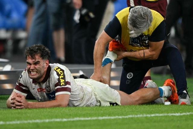 Bordeaux-Begles' French wing Damian Penaud receives treatment before the match enter extra time during the French Top 14 rugby union final match between the Stade Toulousain (Toulouse) and Union Bordeaux-Begles (UBB) at the Stade de France stadium in Saint-Denis, north of Paris, on June 28, 2025. (Photo by Julie SEBADELHA / AFP)